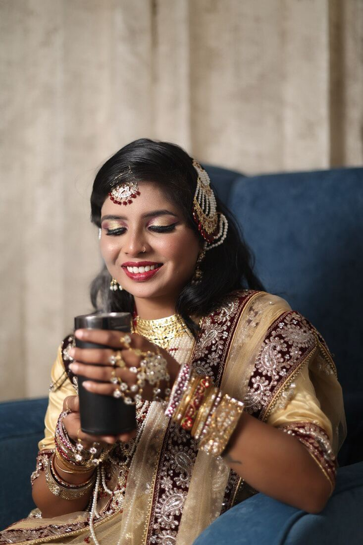 Bride smiling holding a drink