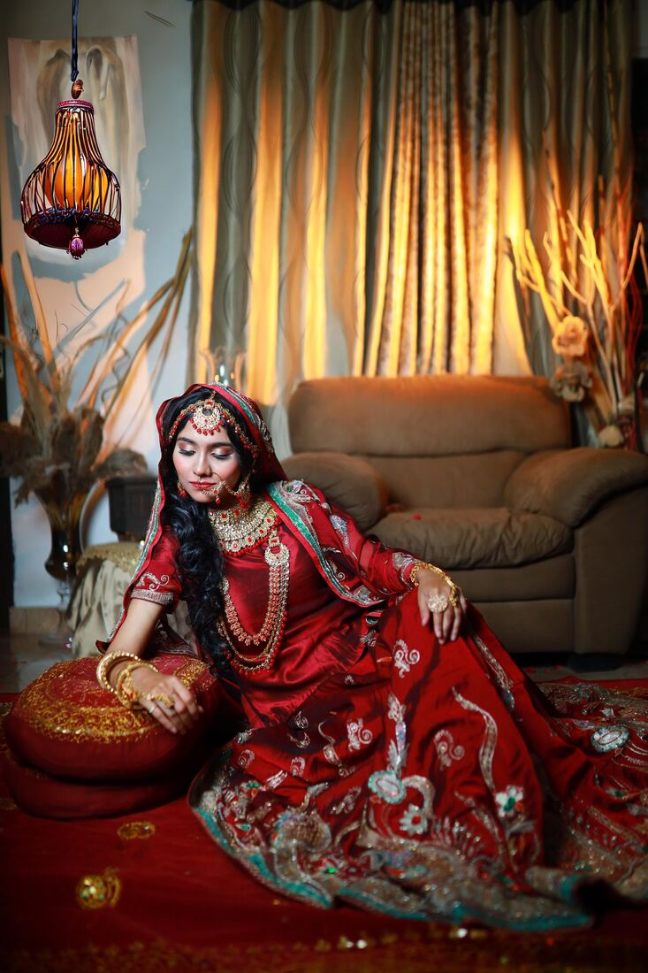 Red bridal outfit seated portrait